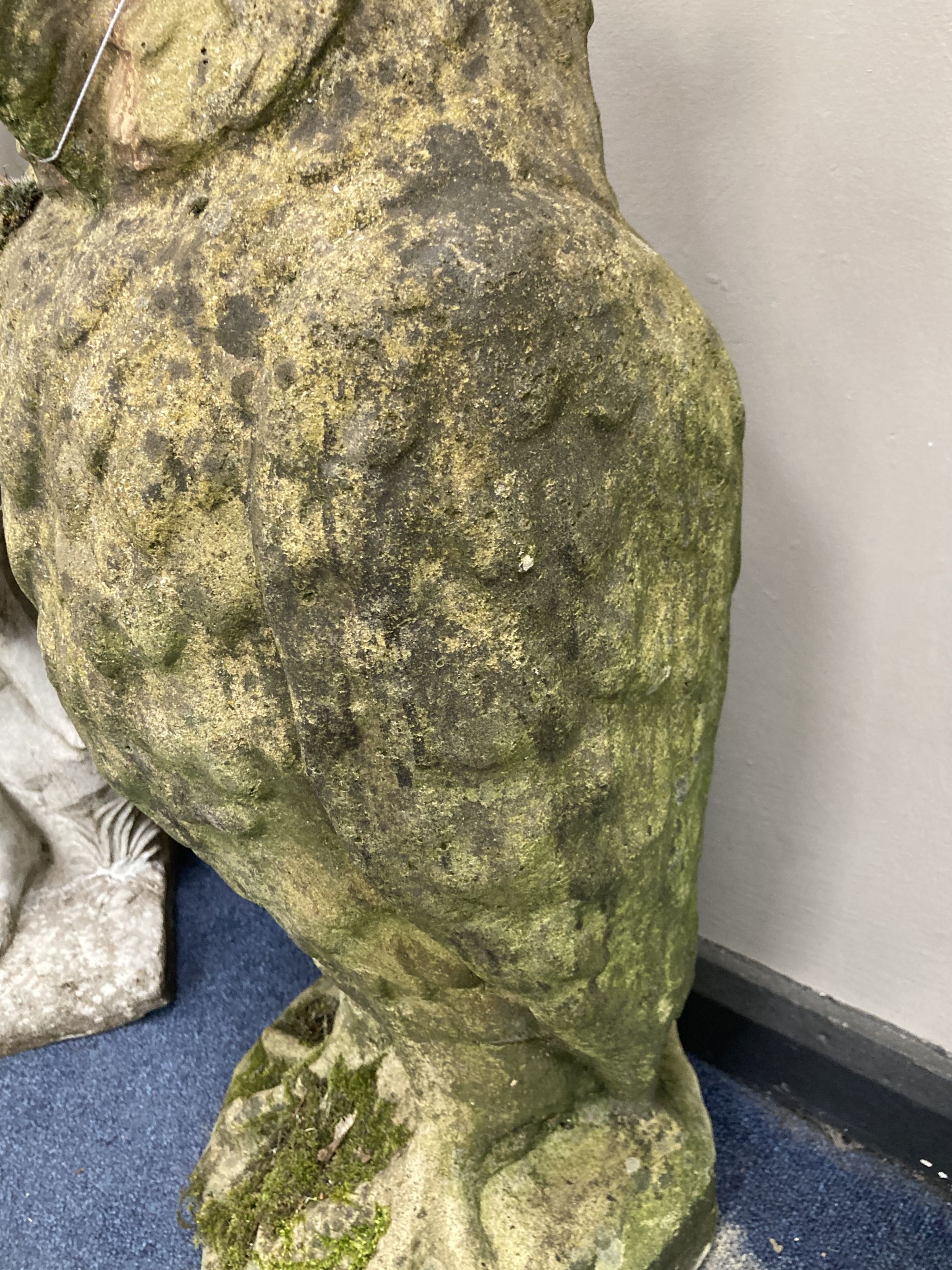 A reconstituted stone garden ornament modelled as an owl, height 70cm